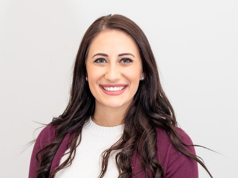 woman in red cardigan smiling
