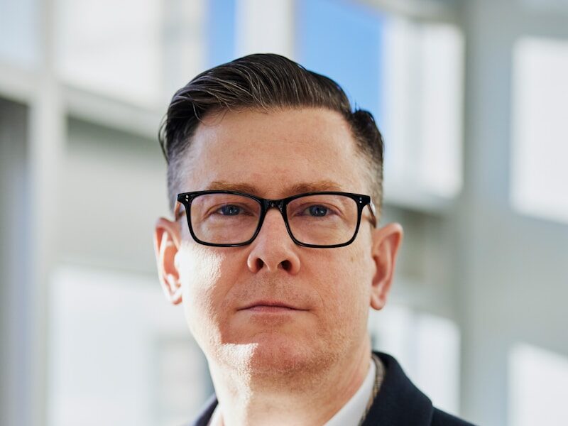 man standing beside wall